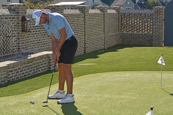 Jacksonville Golfer putting on synthetic grass