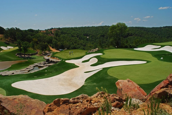 Jacksonville lush green synthetic grass golf course with white sand bunkers and blue sky